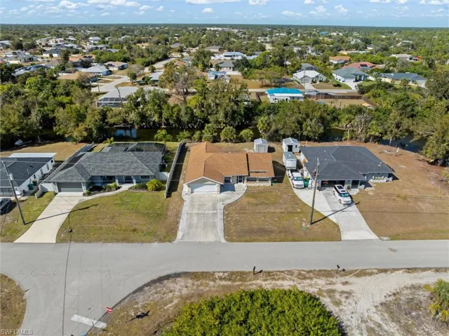 Aerial view of property's location with nearby suburban area