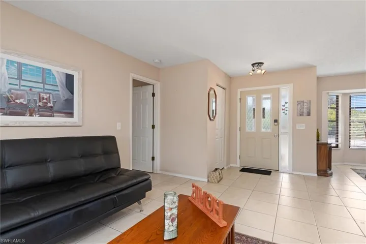 Living room with plenty of natural light and light tile patterned flooring