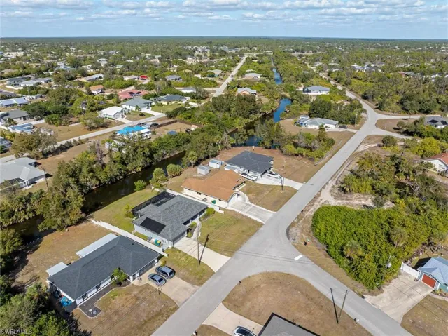 Aerial overview of property's location with nearby suburban area and a nearby body of water