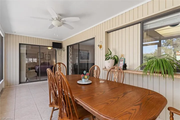 Dining area featuring ornamental molding, a ceiling fan, and tile patterned floors