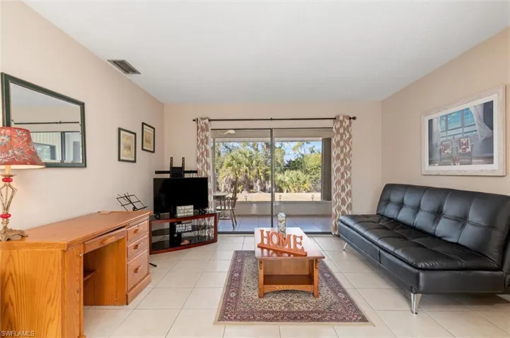 Living room with light tile patterned flooring