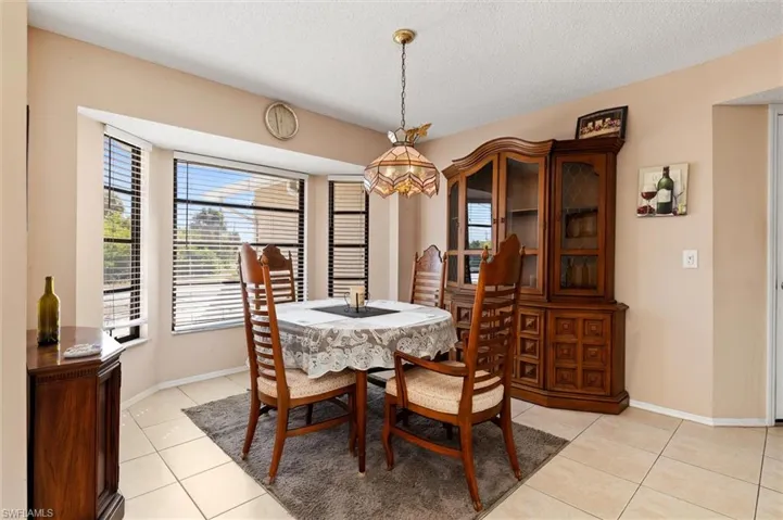Dining room featuring light tile patterned flooring and a textured ceiling