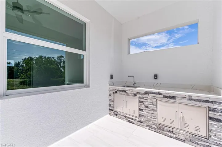 Bathroom featuring ceiling fan and sink