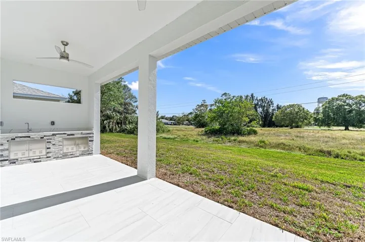 View of patio / terrace with ceiling fan and area for grilling