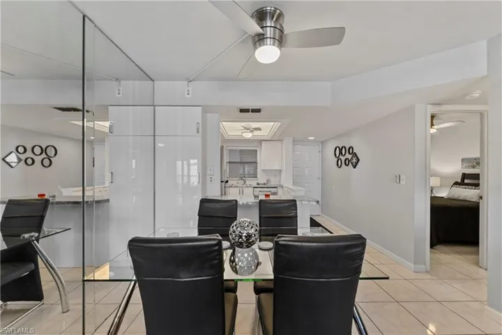 Dining space with light tile patterned floors and ceiling fan