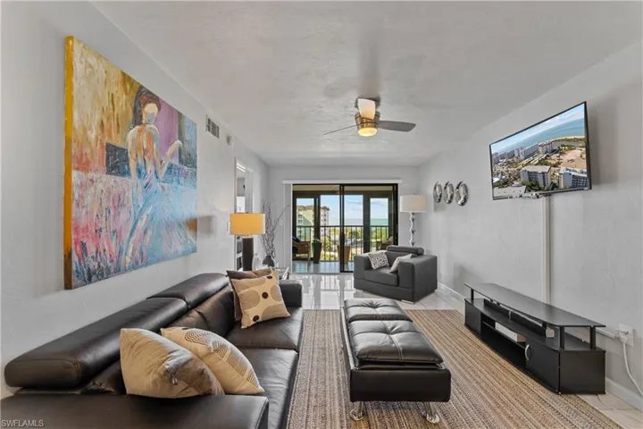 Living area featuring ceiling fan and french doors
