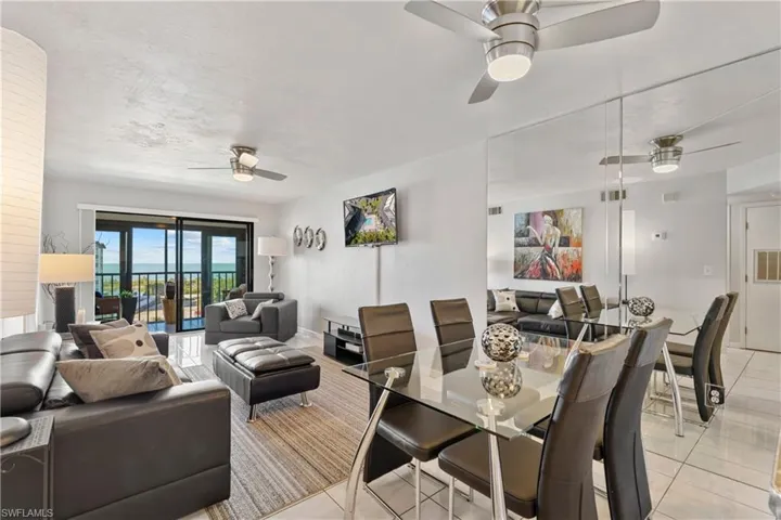 Dining room with a ceiling fan and light tile patterned floors