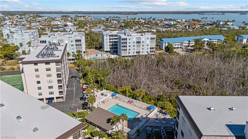 Aerial view of a pool and a large body of water