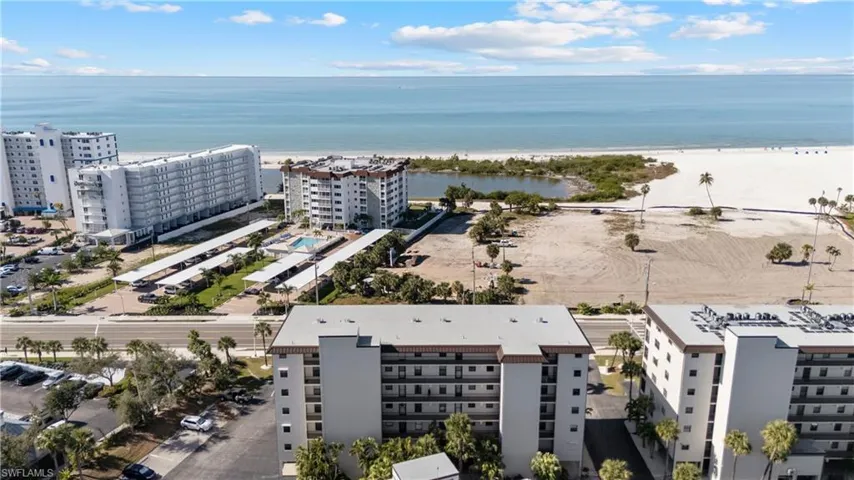 Aerial view of apartment complex and a nearby body of water
