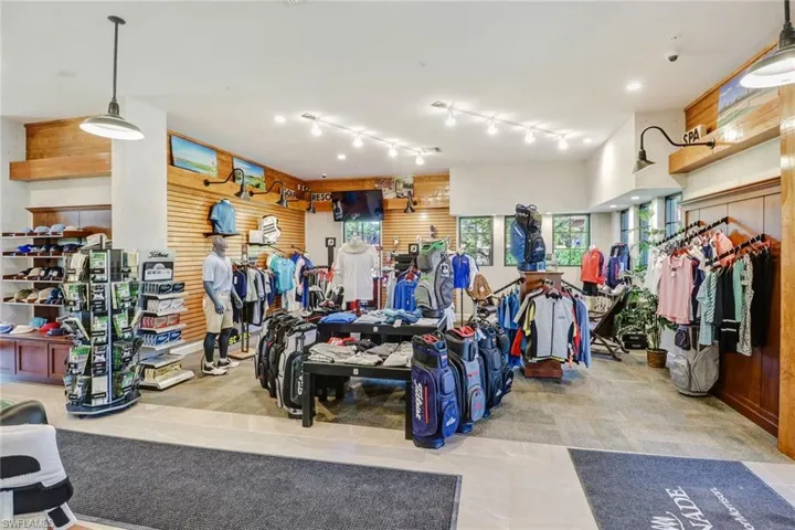 Retail space featuring tile flooring, track lighting, wood paneling, multiple display areas, and exterior windows