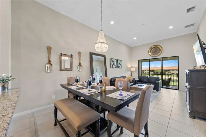 Dining area featuring a crystal chandelier, tile flooring, and light-colored walls