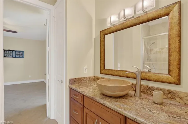 Bathroom featuring a stall shower and vanity