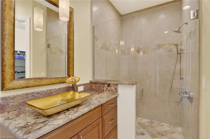 Bathroom featuring a shower stall and vanity