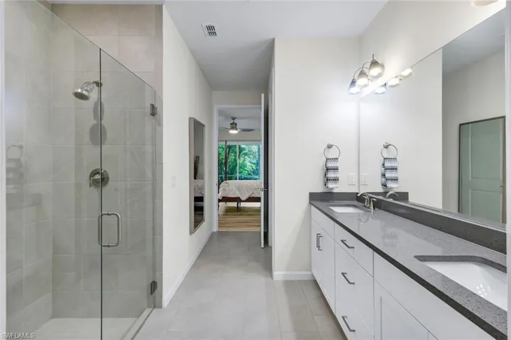 Frameless shower and dual sinks