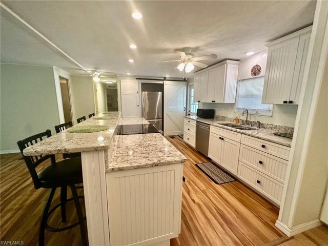 Kitchen features a massive granite prep island & breakfast bar.