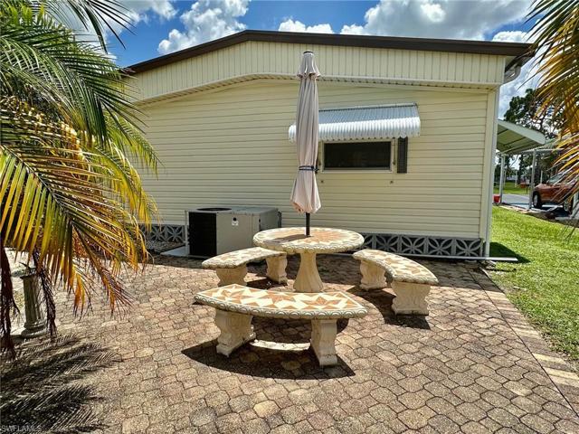 Beautiful paver PATIO among shade & palm trees.