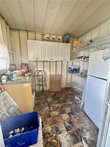 Shed with fridge and plenty of storage space.