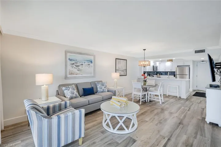 Living room featuring ornamental molding and light wood finished floors