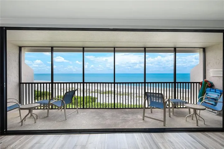 Sunroom featuring a water view, wood finished floors, and healthy amount of natural light
