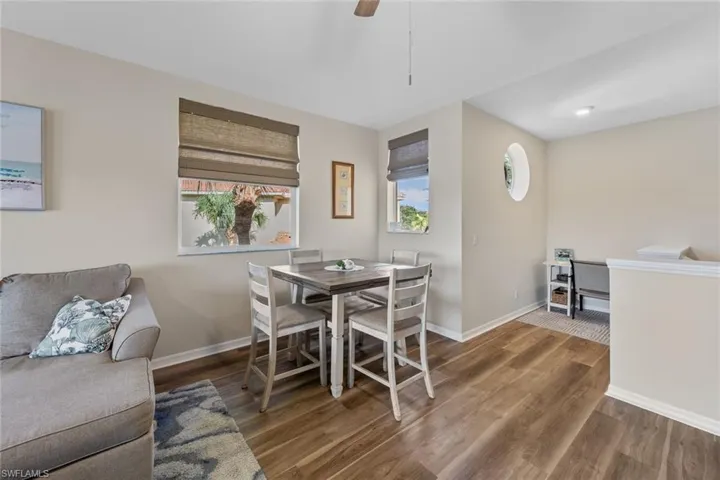 Dining space with wood finished floors and ceiling fan