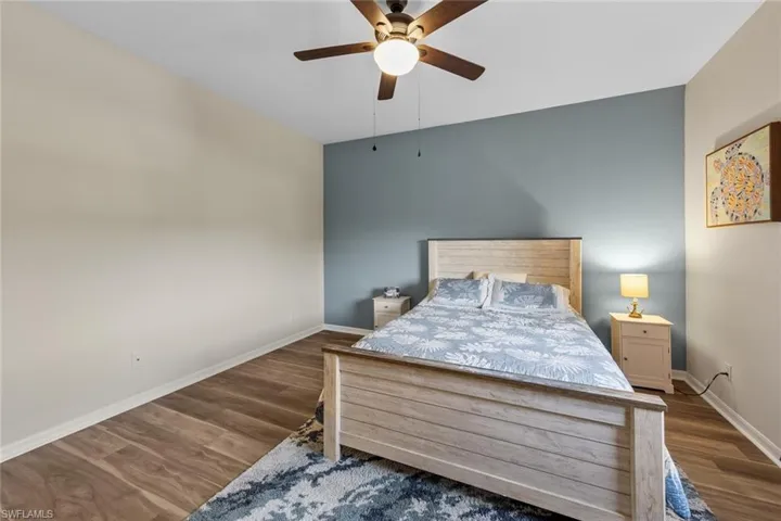 Bedroom featuring dark wood-style flooring and ceiling fan