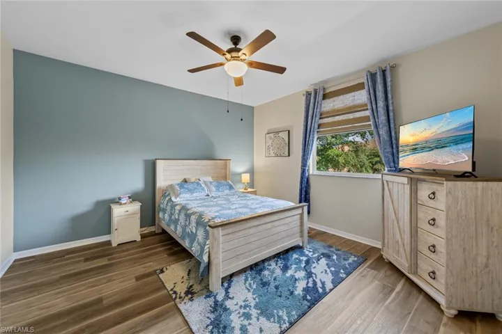 Bedroom with wood finished floors and a ceiling fan