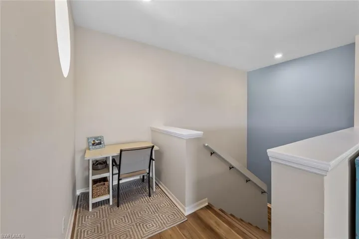 Stairs featuring wood finished floors and recessed lighting
