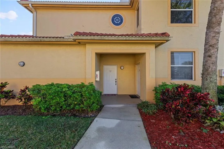Doorway to property with stucco siding and a tile roof