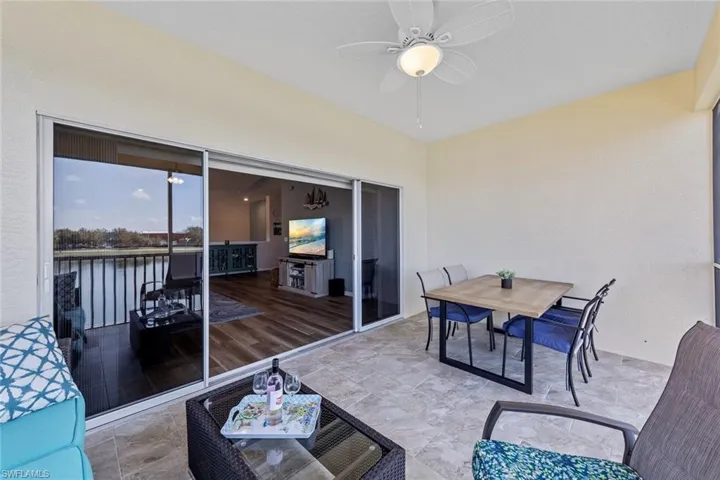 Screened Lanai with ceiling fan and outdoor dining space
