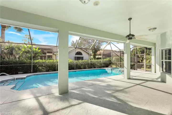 View of swimming pool with a patio, a sunroom, a lanai, and a pool with connected hot tub