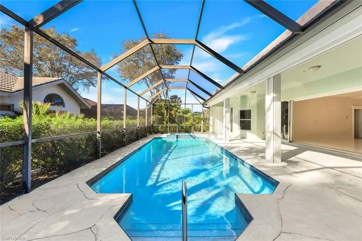 Outdoor pool featuring a patio, a lanai, and a sunroom