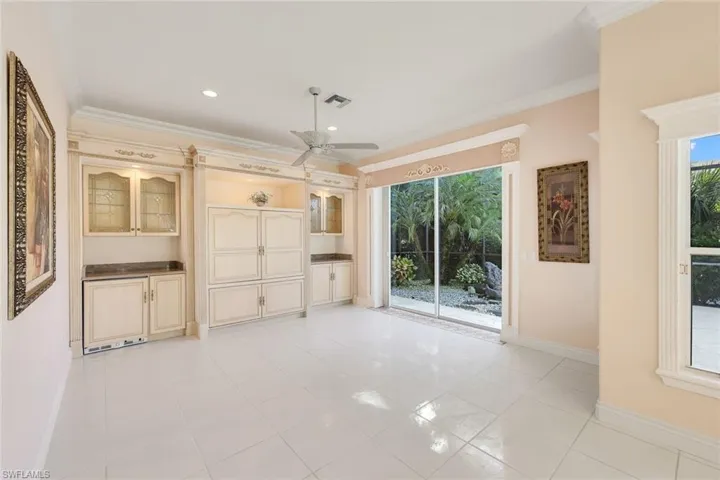 Unfurnished living room featuring ornamental molding, a ceiling fan, light tile patterned floors, healthy amount of natural light, and recessed lighting