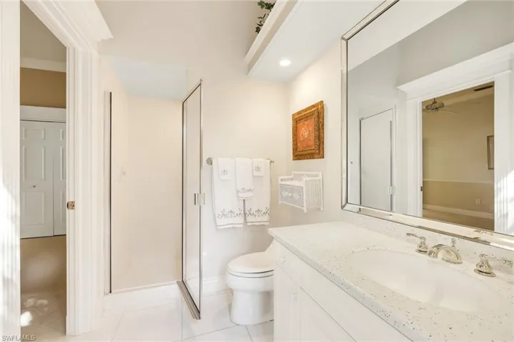 Full bathroom featuring vanity, a shower stall, and light tile patterned flooring