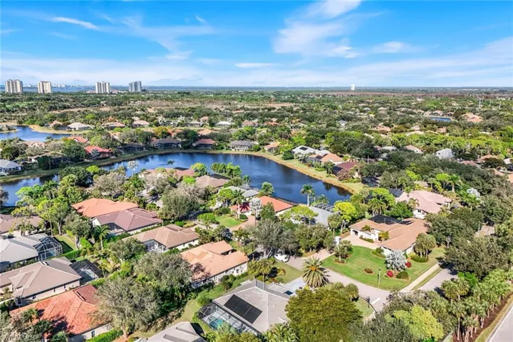 Aerial view of residential area featuring a nearby body of water