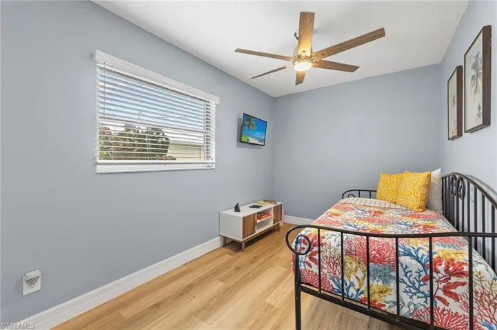 Bedroom featuring ceiling fan and light wood-type flooring
