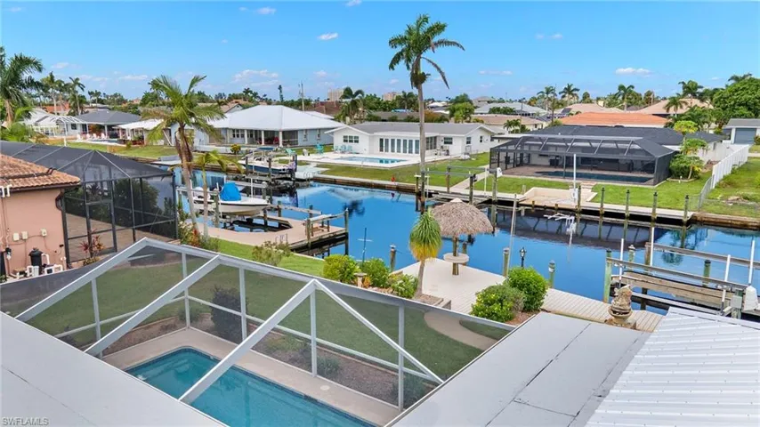 View of dock featuring a water view and a lanai