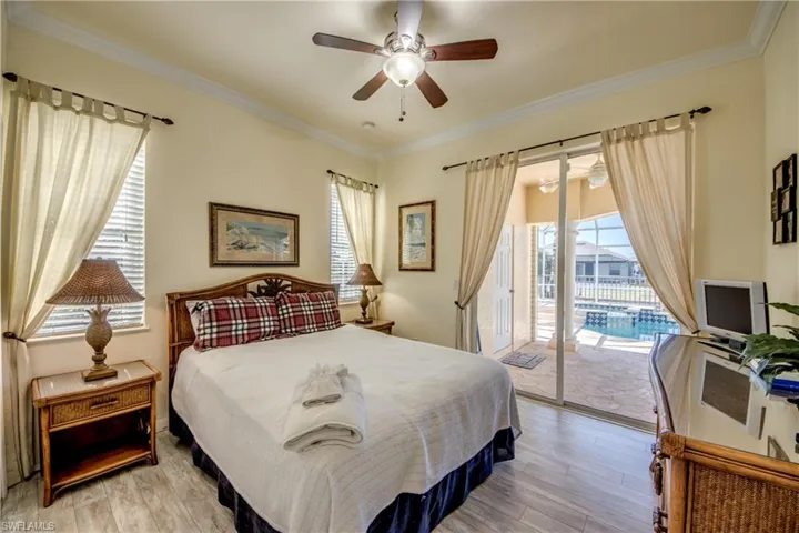 Guest bedroom back of home with sliders out to pool