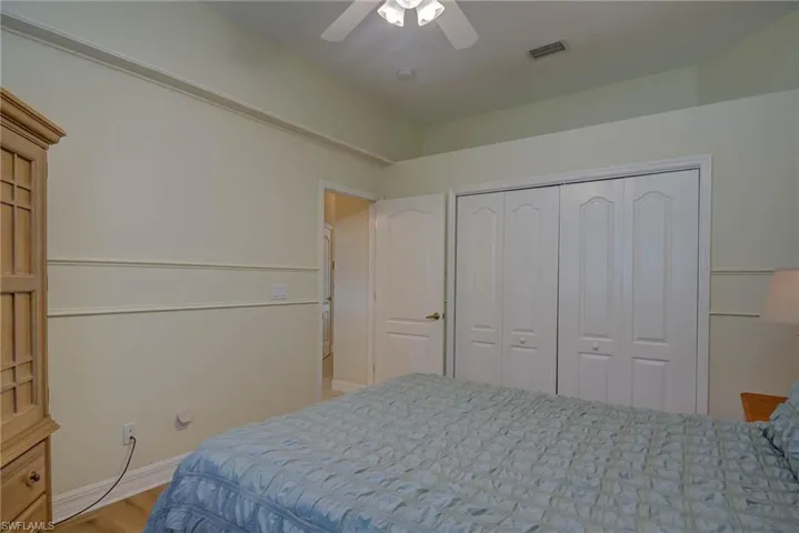 Bedroom featuring ceiling fan, a closet, and light wood finished floors