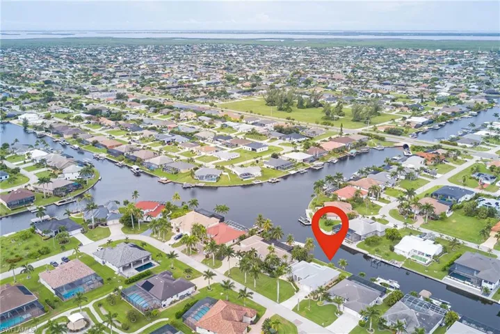 Aerial overview of property's location featuring nearby suburban area and a large body of water