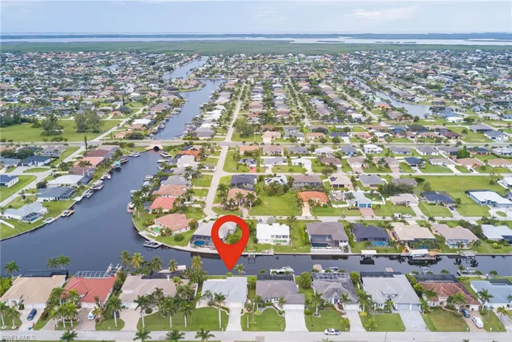 Aerial overview of property's location featuring nearby suburban area and a nearby body of water