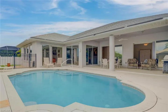View of swimming pool featuring a patio, ceiling fan, and area for grilling