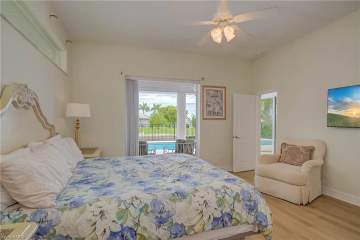 Bedroom featuring access to outside, light wood-type flooring, and a ceiling fan
