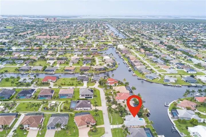 Aerial view of property's location featuring nearby suburban area and a nearby body of water