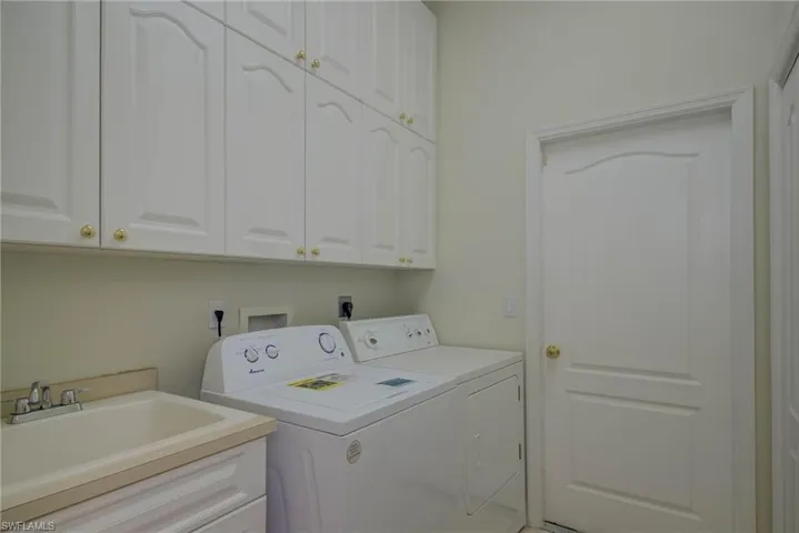 Laundry area with cabinet space and washing machine and dryer