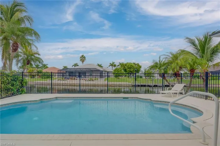 View of swimming pool featuring a patio and a water view