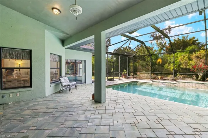 View of swimming pool featuring a patio and a lanai