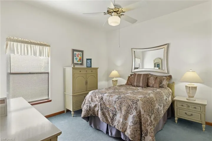 Carpeted bedroom with ceiling fan