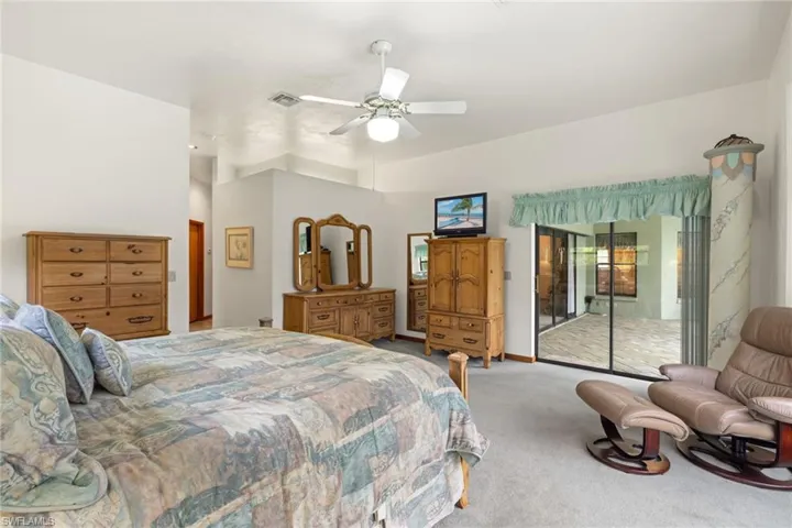 Carpeted bedroom with ceiling fan