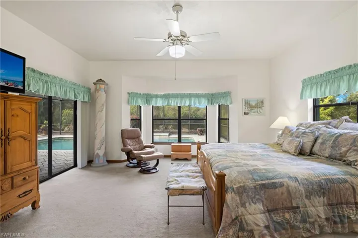 Bedroom with carpet flooring, access to outside, and ceiling fan