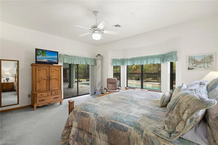 Carpeted bedroom with access to outside and ceiling fan